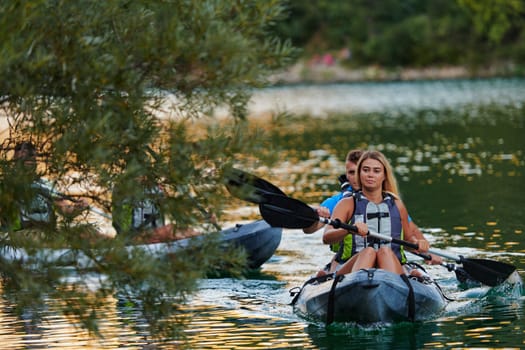 A group of friends enjoying having fun and kayaking while exploring the calm river, surrounding forest and large natural river canyons.