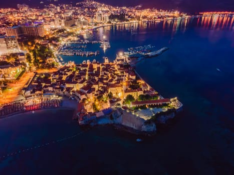 Budva city lights from Montenegro seen from above. Night view. Drone old town Budva at night.