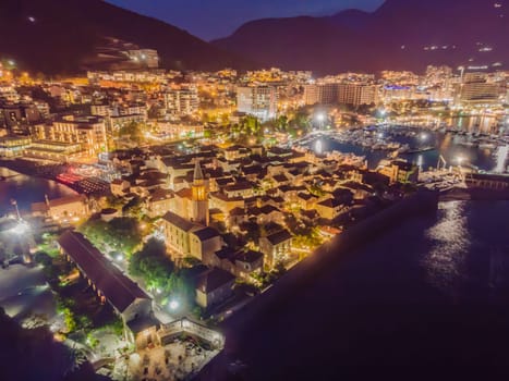 Budva city lights from Montenegro seen from above. Night view. Drone old town Budva at night.