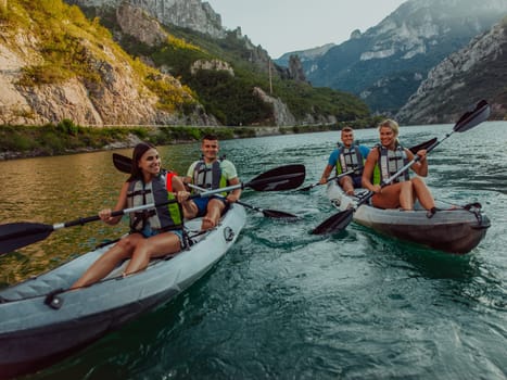 A group of friends enjoying fun and kayaking exploring the calm river, surrounding forest and large natural river canyons during an idyllic sunset