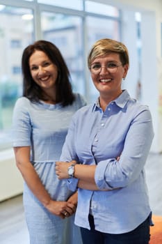 Portrait of a two teacher in a preschool institution, in the background of the classrooms.