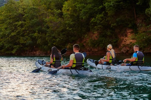 A group of friends enjoying having fun and kayaking while exploring the calm river, surrounding forest and large natural river canyons.