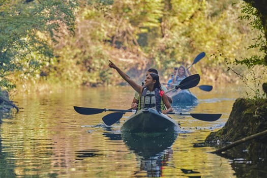 A group of friends enjoying having fun and kayaking while exploring the calm river, surrounding forest and large natural river canyons.