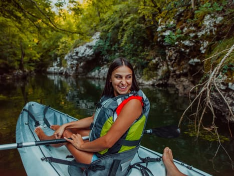 A smiling woman enjoying a relaxing kayak ride with a friend while exploring river canyons.
