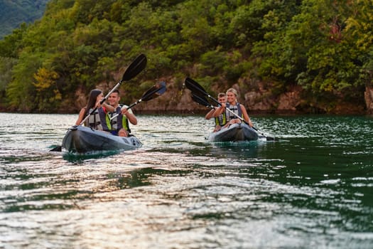 A group of friends enjoying having fun and kayaking while exploring the calm river, surrounding forest and large natural river canyons.