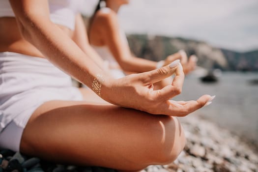 Woman sea yoga. Back view of free calm happy satisfied woman with long hair standing on top rock with yoga position against of sky by the sea. Healthy lifestyle outdoors in nature, fitness concept.