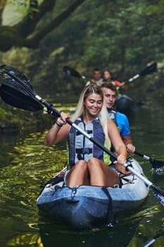 A group of friends enjoying having fun and kayaking while exploring the calm river, surrounding forest and large natural river canyons.