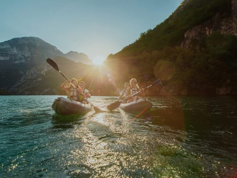 A group of friends enjoying fun and kayaking exploring the calm river, surrounding forest and large natural river canyons during an idyllic sunset