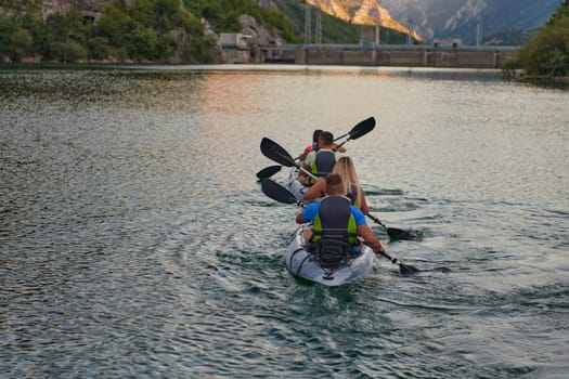 A group of friends enjoying having fun and kayaking while exploring the calm river, surrounding forest and large natural river canyons.