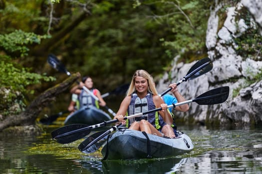 A group of friends enjoying having fun and kayaking while exploring the calm river, surrounding forest and large natural river canyons.