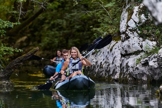 A group of friends enjoying having fun and kayaking while exploring the calm river, surrounding forest and large natural river canyons.