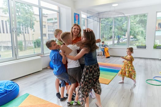 A child hugging a teacher in a modern kindergarten. High quality photo