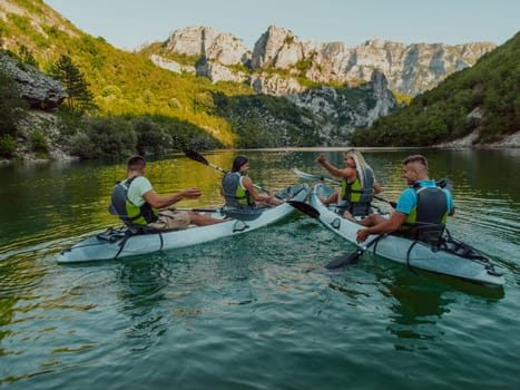 A group of friends enjoying having fun and kayaking while exploring the calm river, surrounding forest and large natural river canyons.