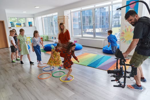 Cameraman films the joyful play and creative exploration of children at a preschool. High quality photo