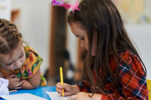 Creative kids sitting in a preschool institution, draw and have fun while they get an education. High quality photo