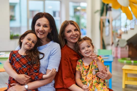 A child hugging a teacher in a modern kindergarten. High quality photo