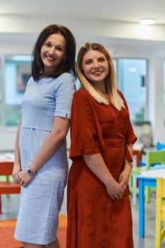 Portrait of a two teacher in a preschool institution, in the background of the classrooms.