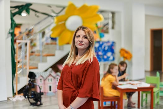 Portrait of a teacher in a preschool institution, in the background of the classrooms. High quality photo