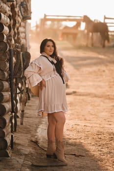 pregnant woman in a dress in the countryside.