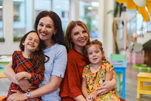 A child hugging a teacher in a modern kindergarten. High quality photo