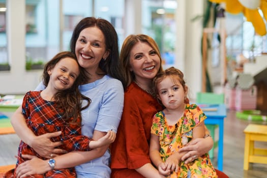 A child hugging a teacher in a modern kindergarten. High quality photo