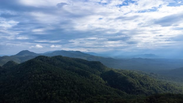 Green mountains and beautiful clouds under blue sky. Beautiful mountain landscape with bright sky.