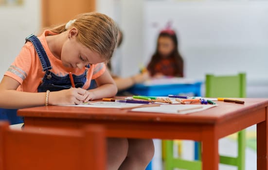 Creative kids sitting in a preschool institution, draw and have fun while they get an education. High quality photo