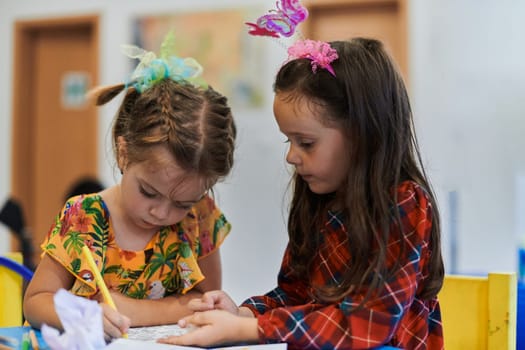 Creative kids sitting in a preschool institution, draw and have fun while they get an education. High quality photo