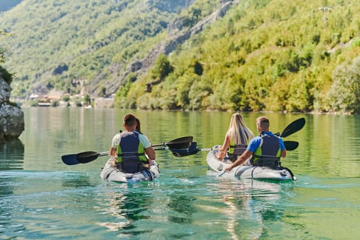 A group of friends enjoying having fun and kayaking while exploring the calm river, surrounding forest and large natural river canyons.