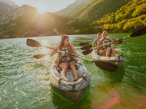 A group of friends enjoying fun and kayaking exploring the calm river, surrounding forest and large natural river canyons during an idyllic sunset