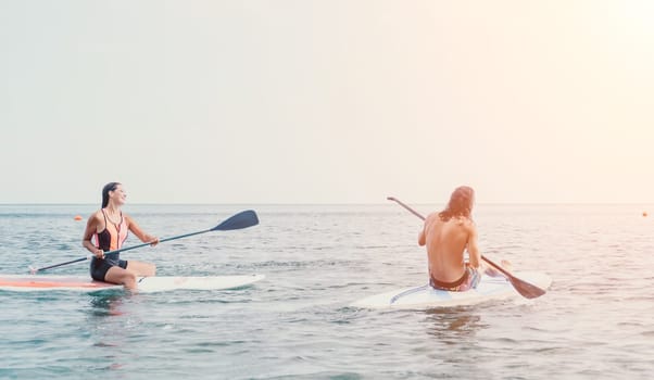 Woman sup yoga. Happy young sporty woman practising yoga pilates on paddle sup surfboard. Female stretching doing workout on sea water. Modern individual female outdoor summer sport activity