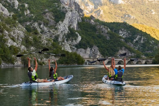 A group of friends enjoying having fun and kayaking while exploring the calm river, surrounding forest and large natural river canyons.