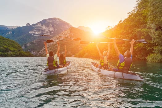 A group of friends enjoying fun and kayaking exploring the calm river, surrounding forest and large natural river canyons during an idyllic sunset