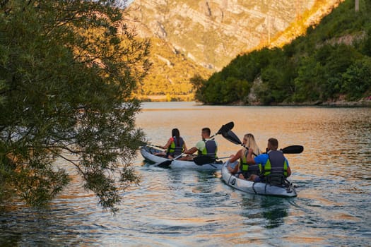 A group of friends enjoying having fun and kayaking while exploring the calm river, surrounding forest and large natural river canyons.