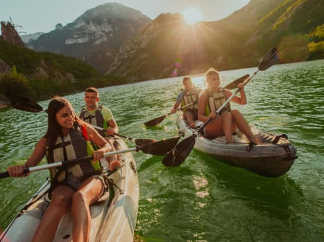 A group of friends enjoying fun and kayaking exploring the calm river, surrounding forest and large natural river canyons during an idyllic sunset