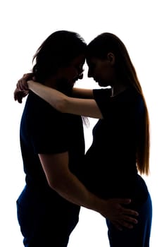 Photo of cheerful young man standing with his pregnant woman isolated over white background wall. beautiful young couple expecting baby standing together and touching belly