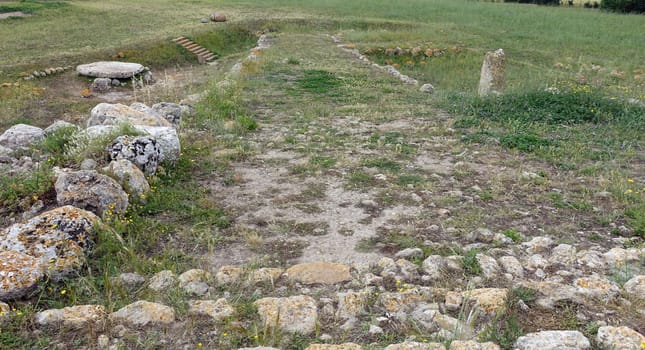 Sassari, Sardinia in Italy, May 18 2023. Entrance ramp to the altar of Monte d'Accoddi with a menhir and a sacred stone on the sides. Dating back to 4000 BC.