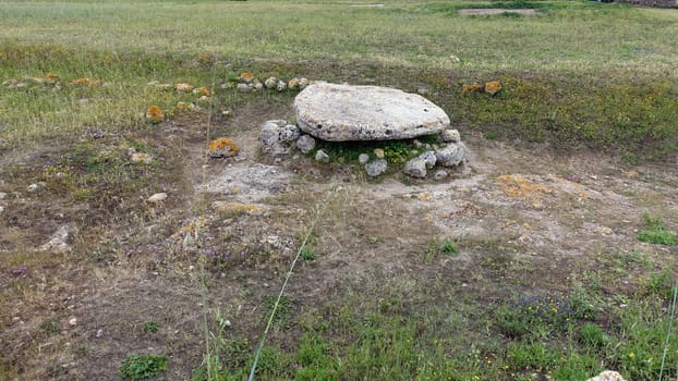 Sassari, Sardinia in Italy, May 18 2023. A sacred circular stone in front of the altar of Monte d'Accoddi. Dating back to 4000 BC.