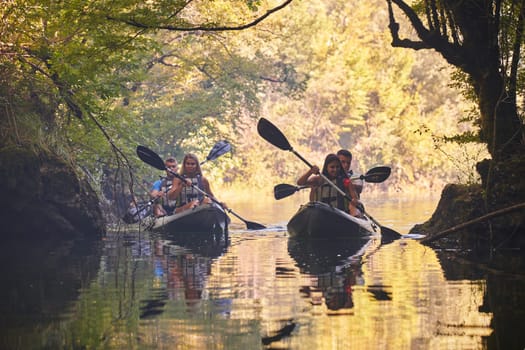 A group of friends enjoying having fun and kayaking while exploring the calm river, surrounding forest and large natural river canyons.