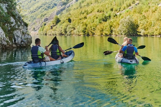 A group of friends enjoying having fun and kayaking while exploring the calm river, surrounding forest and large natural river canyons.