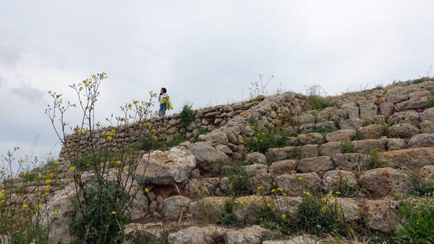 Sassari, Sardinia in Italy, May 18 2023. Staircase of the altar of Monte d'Accoddi in Sardinia. Tourists on the phone.