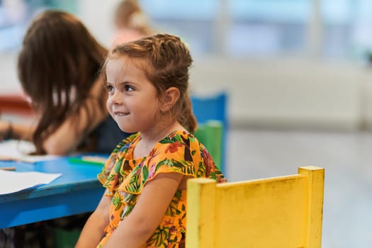 Creative kids sitting in a preschool institution, draw and have fun while they get an education. High quality photo