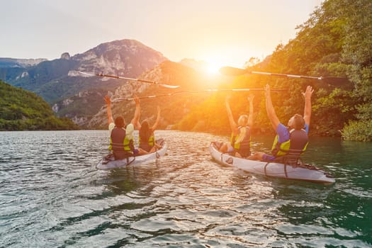 A group of friends enjoying fun and kayaking exploring the calm river, surrounding forest and large natural river canyons during an idyllic sunset