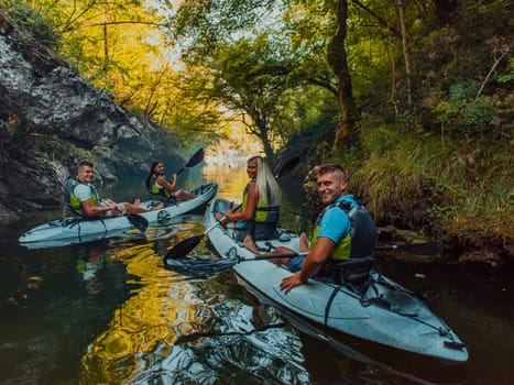 A group of friends enjoying having fun and kayaking while exploring the calm river, surrounding forest and large natural river canyons.