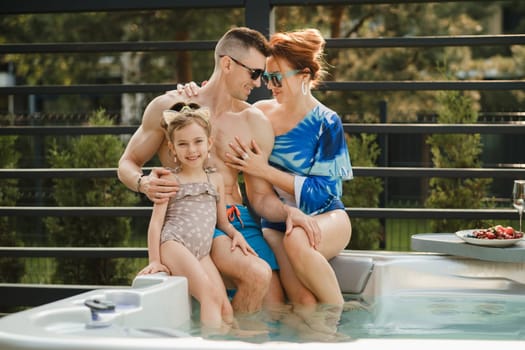 In summer, the family rests in the outdoor hot tub.