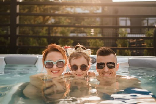 In summer, the family rests in the outdoor hot tub.