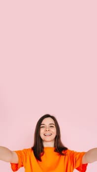 Vibrant Social Media Storytelling: Beautiful and Joyful Woman in Colorful Attire, Recording Instagram/Twitter Post - Influencer and Informant Concept, Isolated on Pink Background