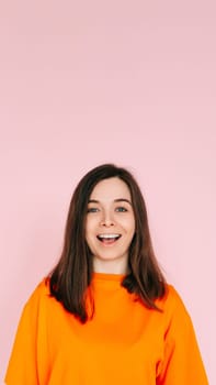 Surprised Delight: Cheerful Woman Expressing Amazement with Open Mouth - Joyful Reaction and Positive Energy on Vibrant Pink Background