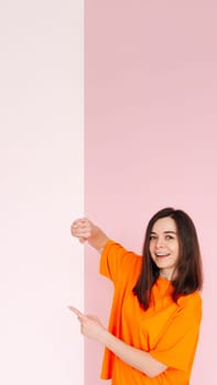 Affordable Deals: Optimistic Girl Holding Paper Board with Empty Space - Presentation of Cheap Prices for Advertising, Isolated on Pink Background