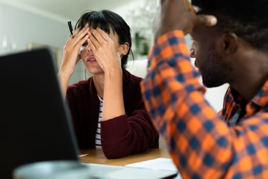 Tensed multiracial young couple planning household budget at home. unaltered, lifestyle, stress, finance, planning, calculating, expenses, problems, savings.